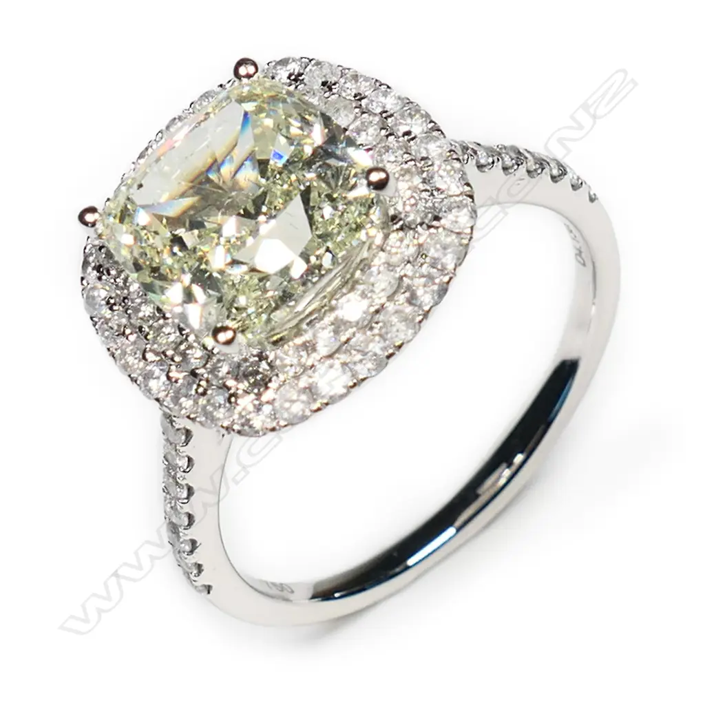 An 18ct white gold and diamond halo ring, Image 1++