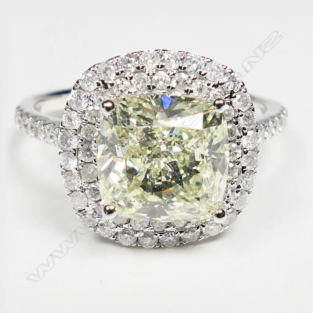 An 18ct white gold and diamond halo ring, Image 1++