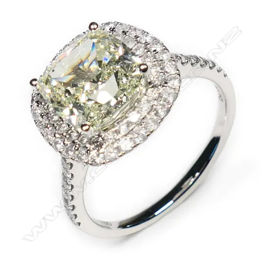 An 18ct white gold and diamond halo ring,