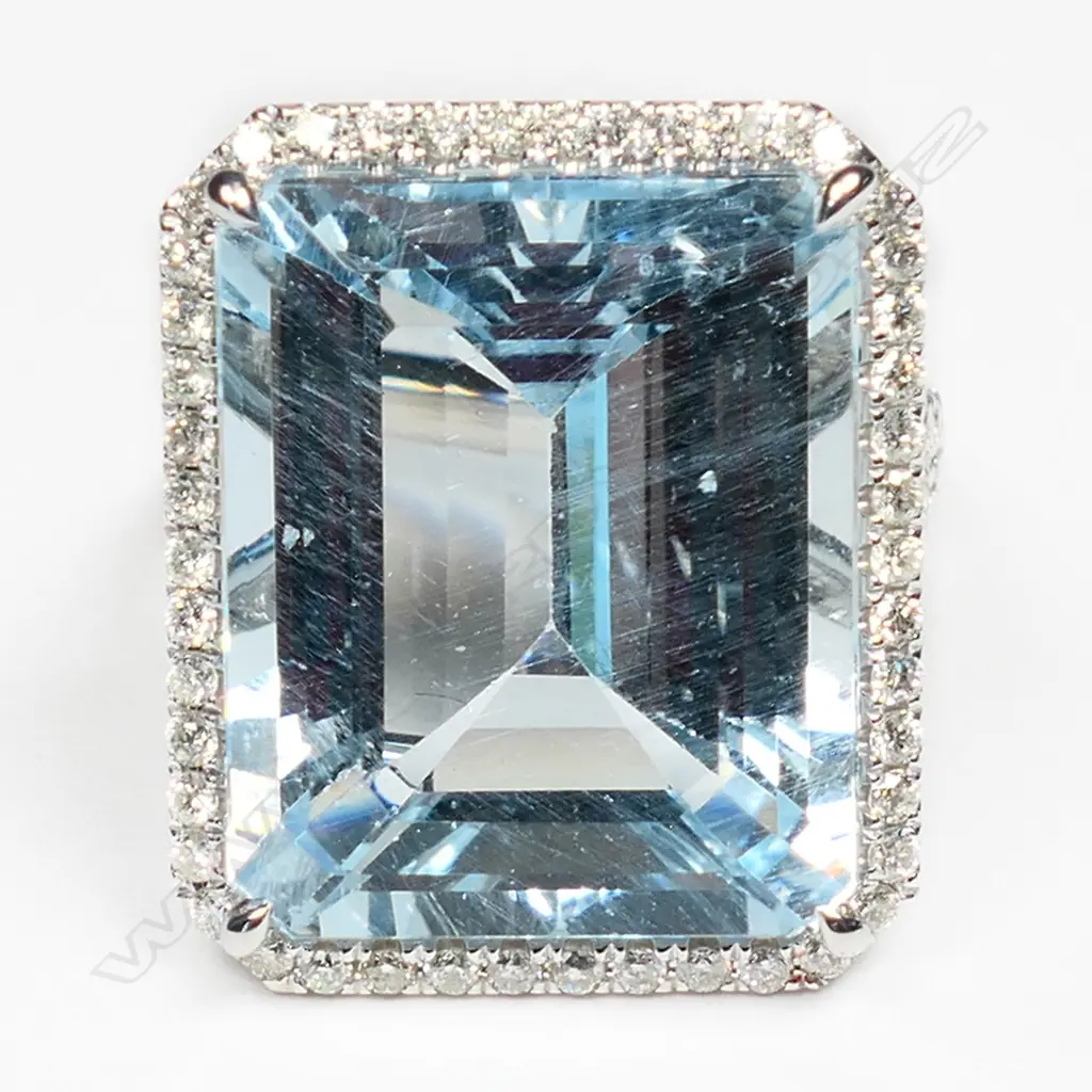 A 14ct white gold aquamarine and diamond halo ring, Image 1++