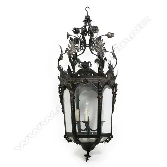 A large wrought iron, pressed metal and glass French style portico light,