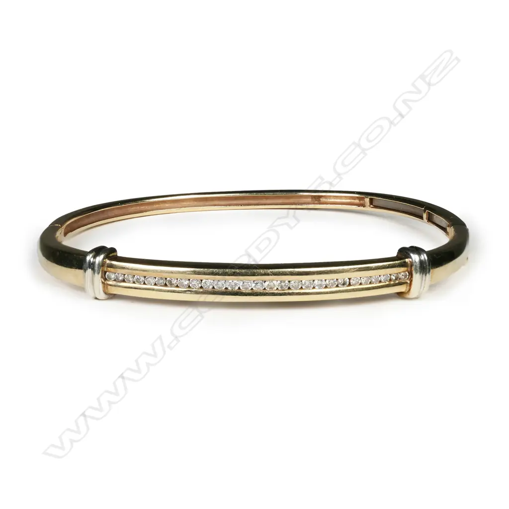 A 9ct yellow gold and channel set diamond hinged bangle, Image 1++