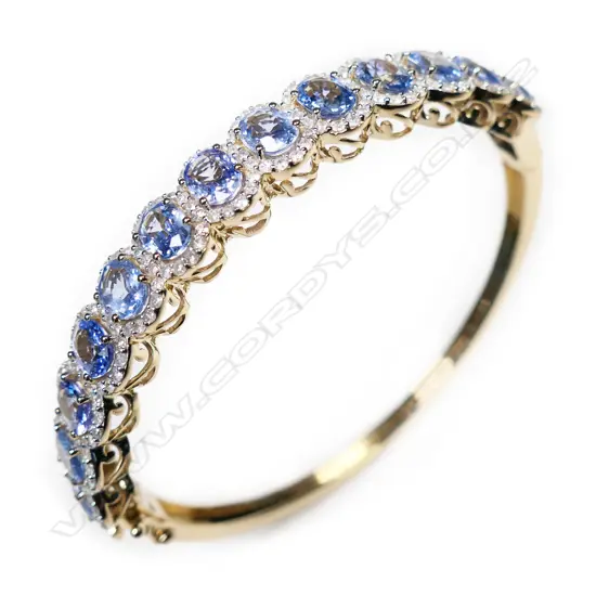 A 14ct gold, sapphire and diamond antique style bangle,