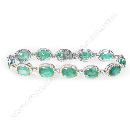 A 14ct white gold, emerald and diamond halo bracelet,