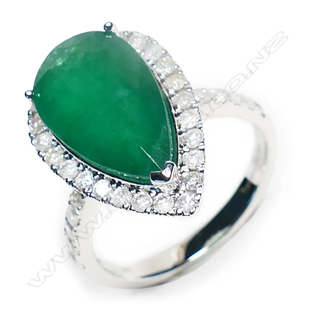 A 14ct white gold, emerald and diamond halo ring, Image 1++