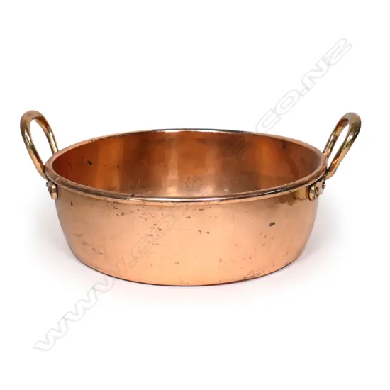 A large copper two handled pan,