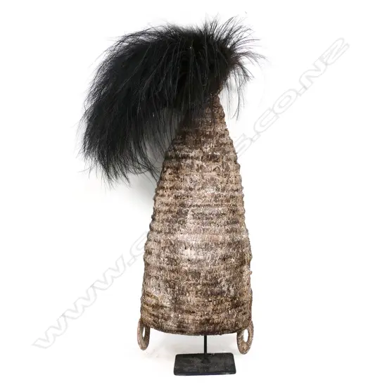 A Melanesian constructed and woven palm fibre headdress, surmounted by a coronet of cassowary feathers,