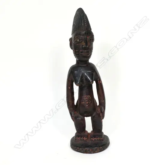 A Nigerian Yoruba carved wood ibeji female figure,