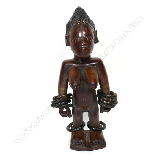 A Nigerian Yoruba carved wood ibeji female figure,