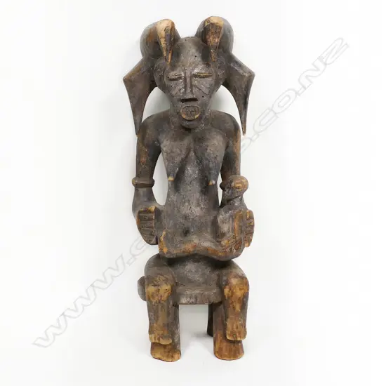 An African carved wood maternity figure, possibly Senufo, Ivory Coast,