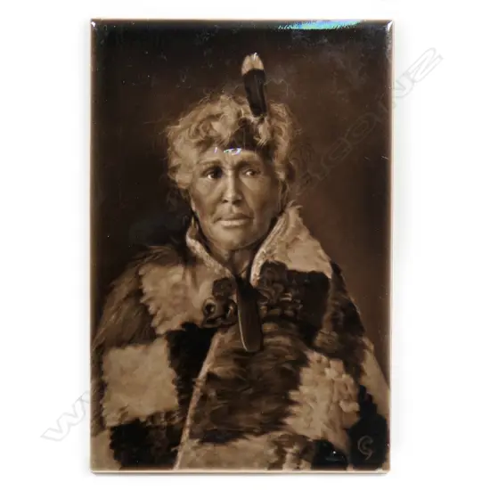 A c.1900 Sherwin & Cotton Māori portrait tile of the guide 'Sophia', depicted wearing a korowai (cloak), pounamu tiki and pendant and huia feather in her hair, the artist George Cartlidge’s monogram bottom right, maker's marks to reverse. 225 x 150mm.