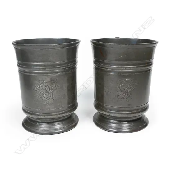 A pair of early Victorian pewter pint mugs,