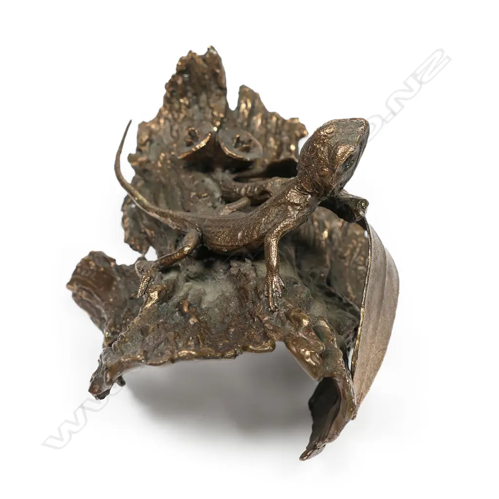 A small bronze sculpture of an Australian lizard,  on bark section with gum nuts, Image 1++