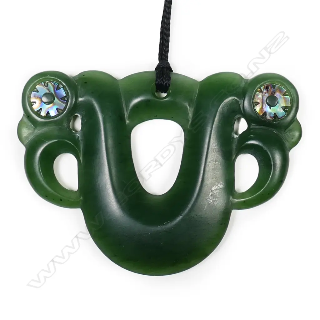 A contemporary pounamu pekapeka, double sided, with serrated paua inlaid ring eyes. Image 1++