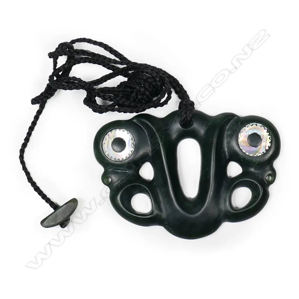 A contemporary pounamu pekapeka, with serrated paua inlaid ring eyes. Image 1++