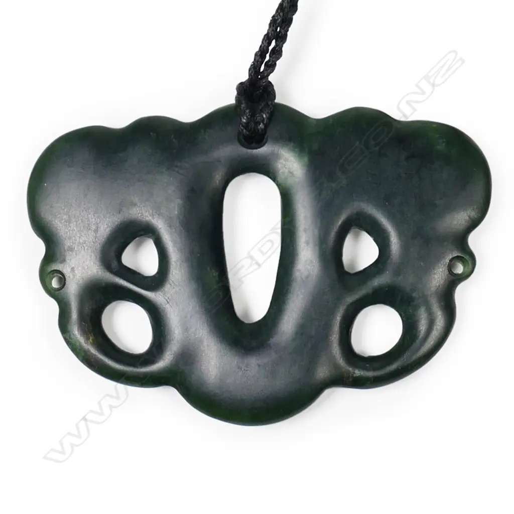A contemporary pounamu pekapeka, with serrated paua inlaid ring eyes. Image 1++