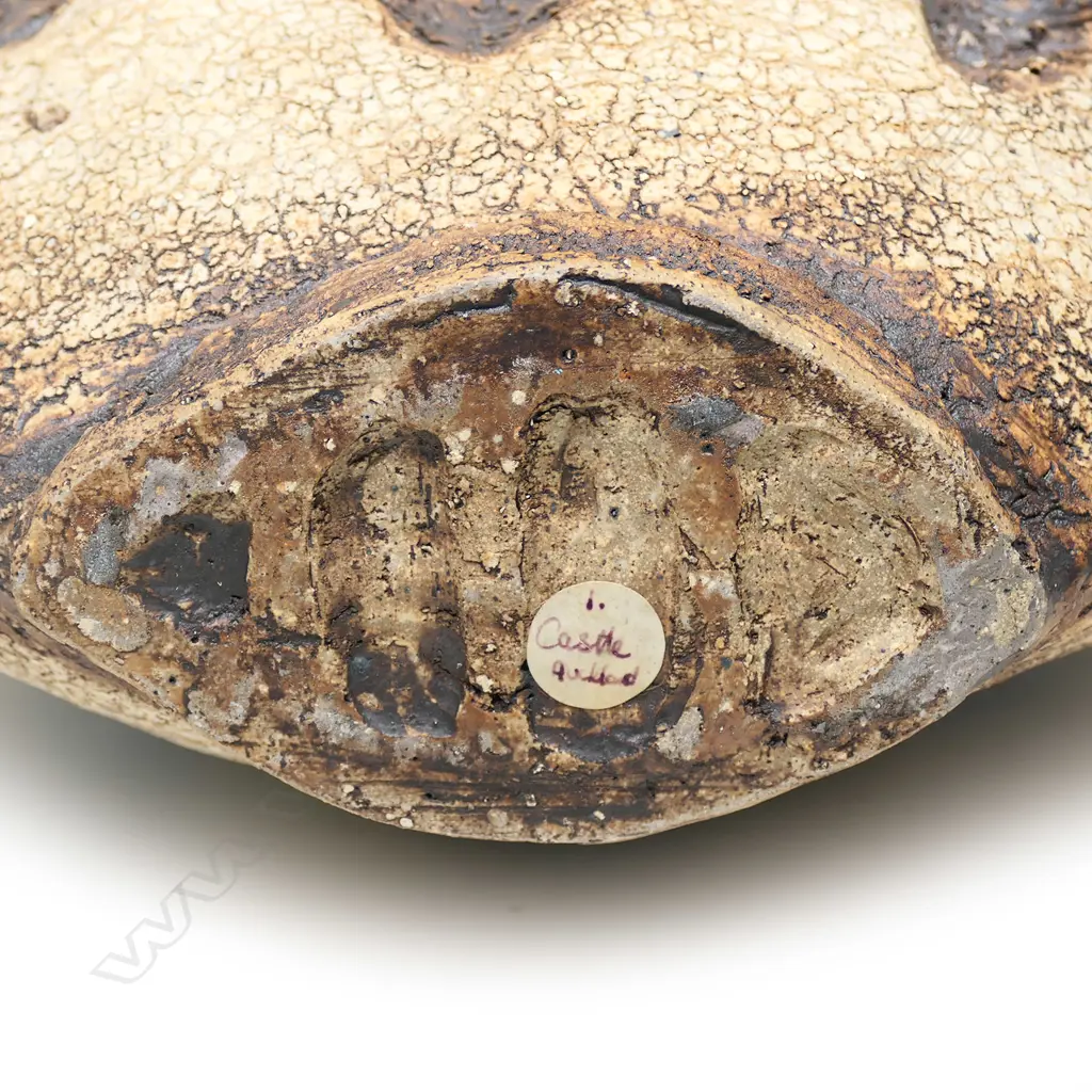 A Len Castle discoid stoneware vase, three heavily combed vertical rope impressions to each side, concave mouth, iron oxide washed matt glaze, impressed potter’s mark. H.355mm Image 1++
