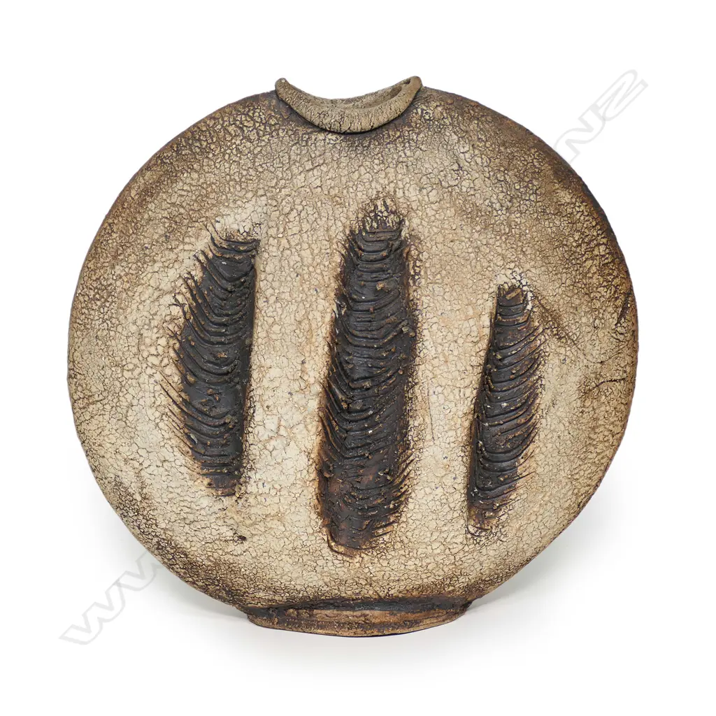 A Len Castle discoid stoneware vase, three heavily combed vertical rope impressions to each side, concave mouth, iron oxide washed matt glaze, impressed potter’s mark. H.355mm Image 1++
