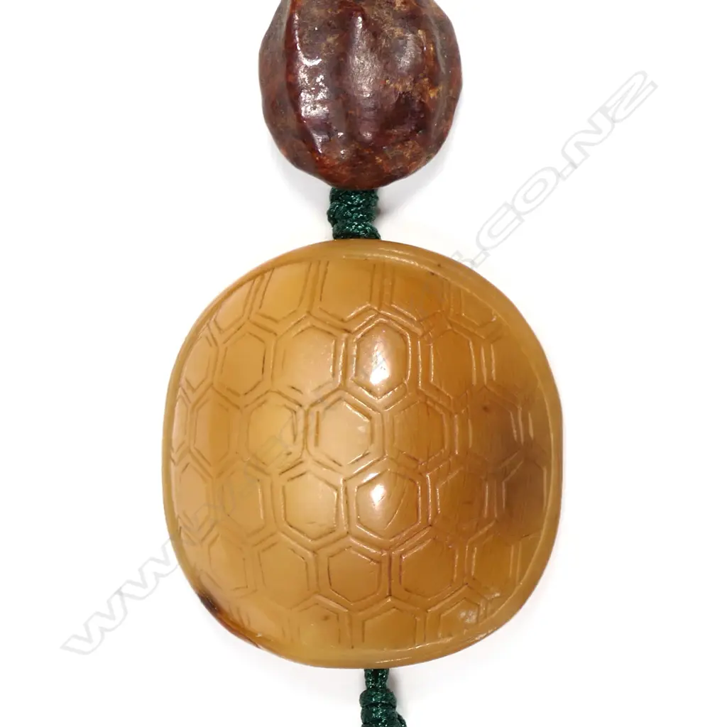 A Chinese Qing carved hornbill pendant with ancient jade beads Image 1++