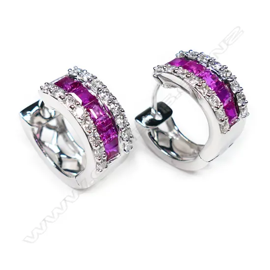 A pair of 18ct white gold ruby and diamond huggie style earrings,