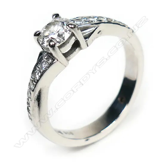 A modern platinum and diamond solitaire ring,