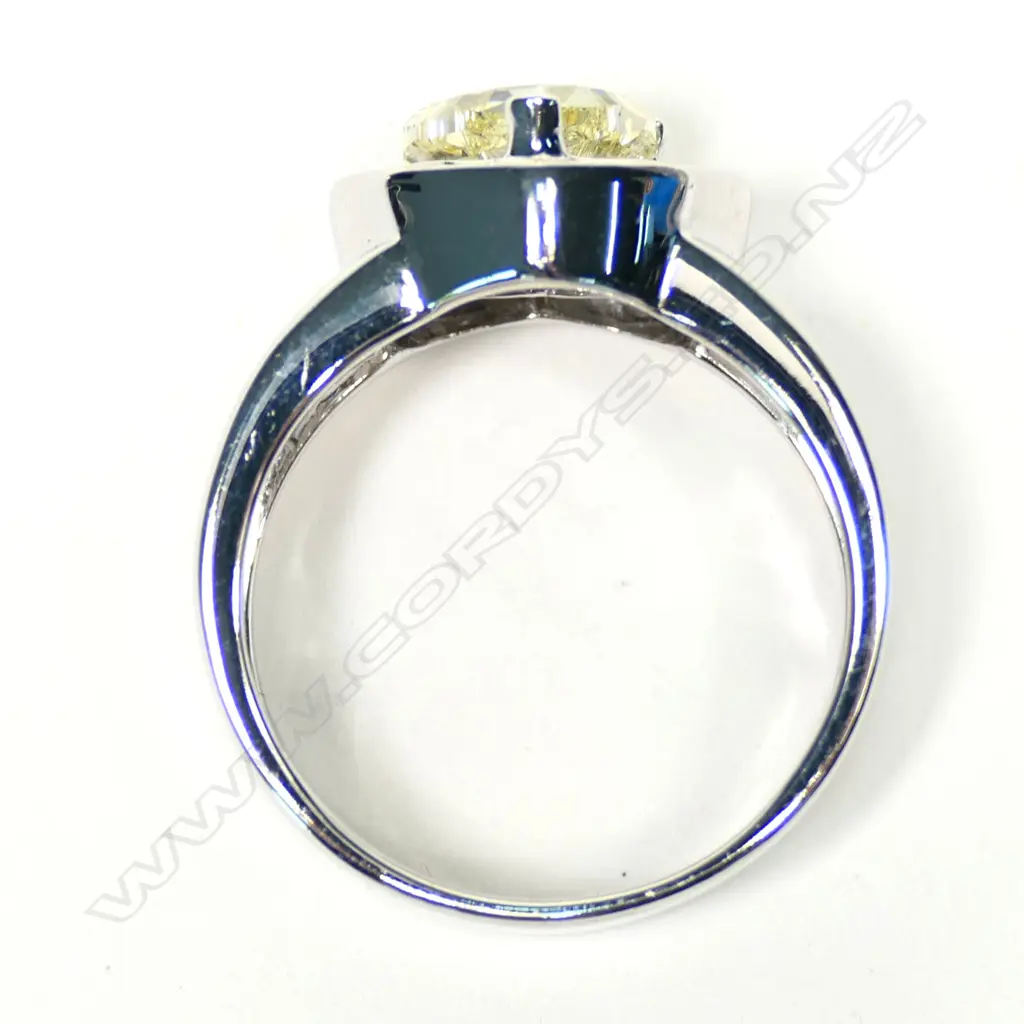 An 18ct white gold, fancy yellow diamond heart halo ring, Image 1++