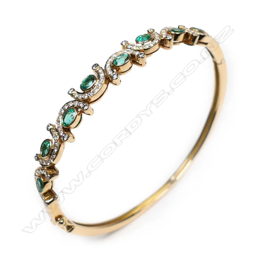 An 18ct gold, diamond and emerald hinged bangle, Image 1++