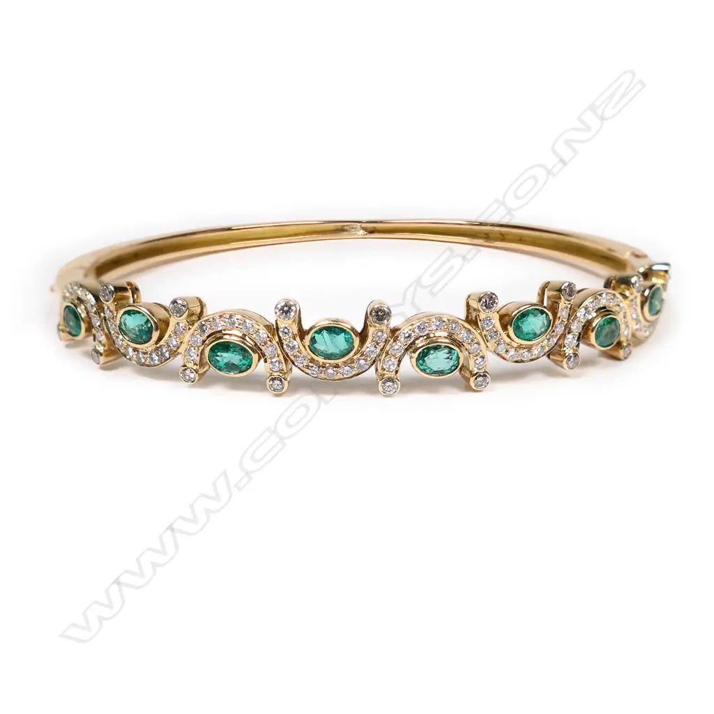 An 18ct gold, diamond and emerald hinged bangle, Image 1++