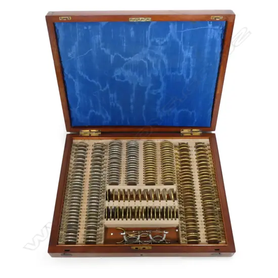 A New Zealand colonial opticians' cased set of prescription test lenses, in fitted mahogany case,