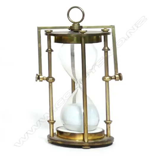 An old brass and hour-glass nautical sand timer,