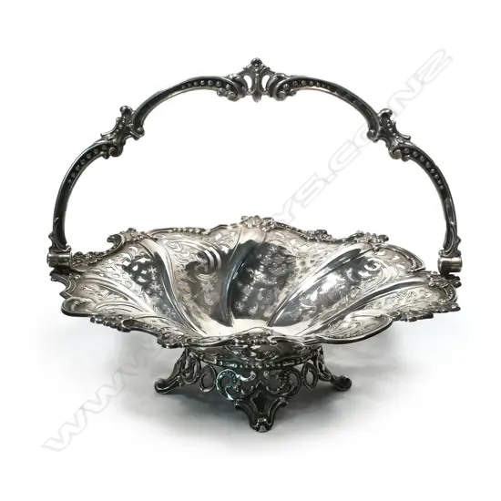 A Victorian silver fruit basket, wrythen fluted and decoratively pierced, with a cast swing handle,