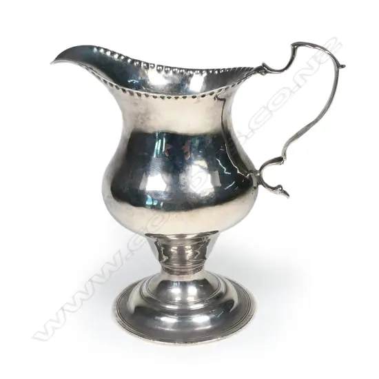 A George III silver helmet shape creamer, with acanthus capped handle,