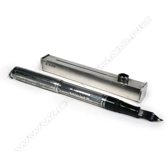 A lady's Waterman's silver fountain pen and a silver sealing wax holder;