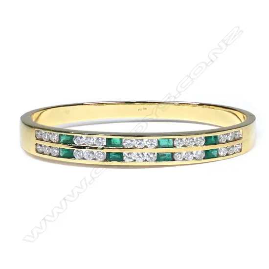 An 18ct gold, diamond and emerald hinged bangle,