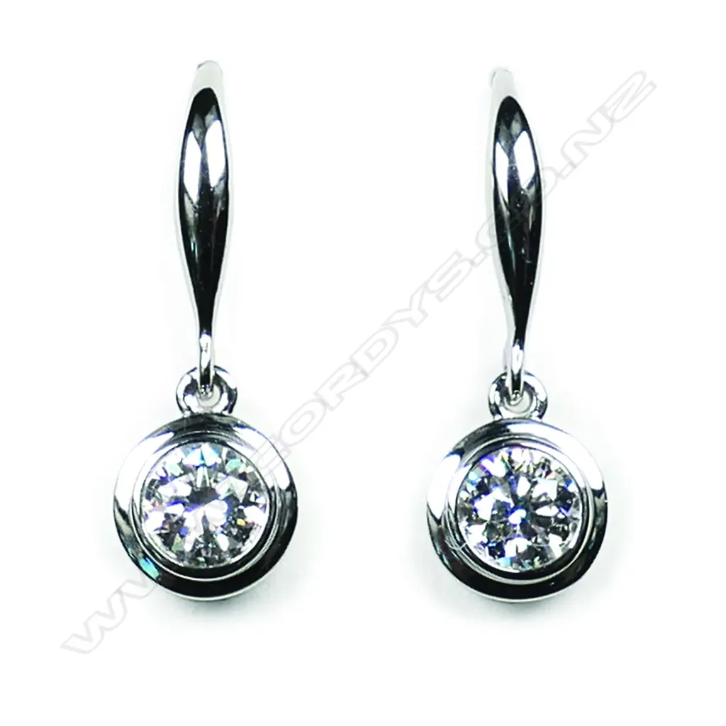 A pair of 18ct white gold and diamond solitaire earrings, Image 1++