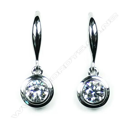 A pair of 18ct white gold and diamond solitaire earrings,