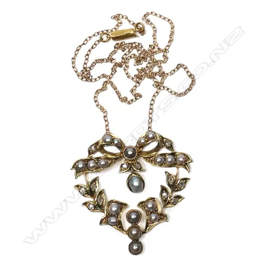 An Edwardian 15ct gold pendant set with seed pearls and mine cut diamonds,