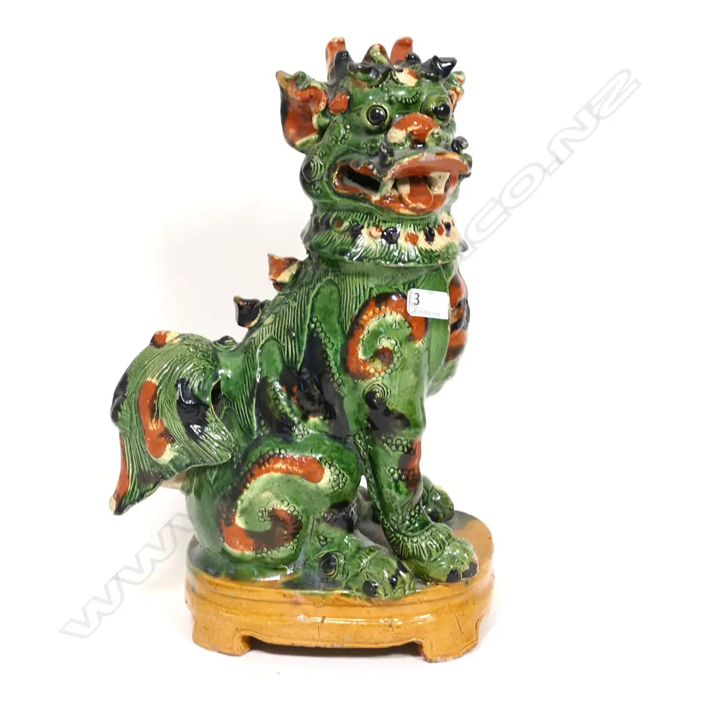 A Chinese green and ochre splash glazed pottery figure of a kylin Image 1++