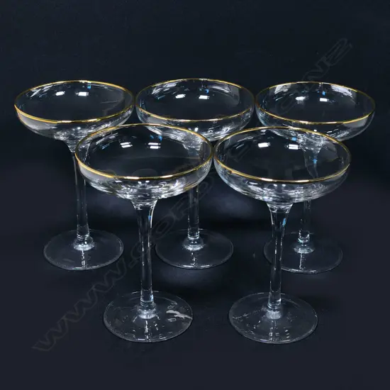 A set of  five gold rimmed champagne coupes