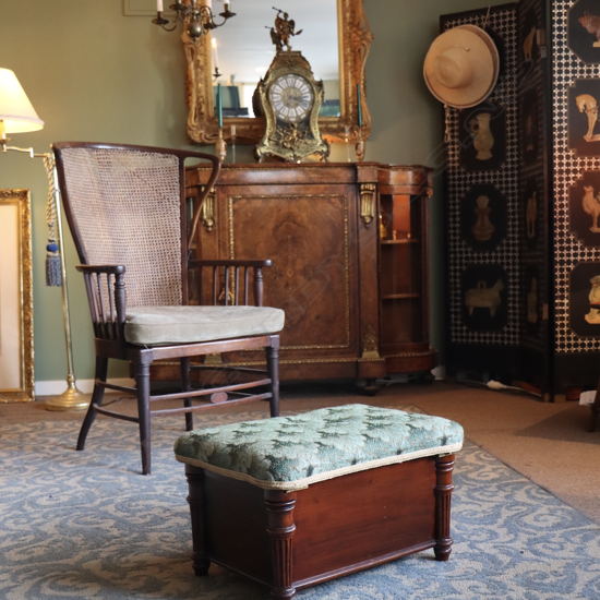 A Georgian upholstered mahogany footstool with cellarette