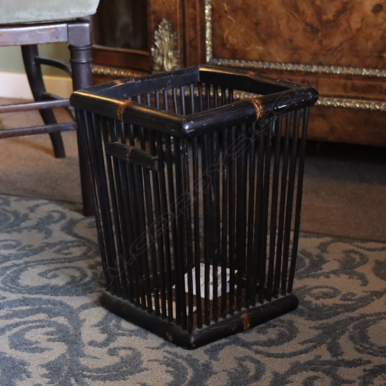 A stylish ebonized bamboo paper bin