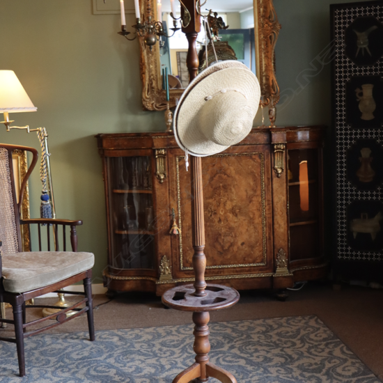A vintage coat and umbrella stand with brass handles