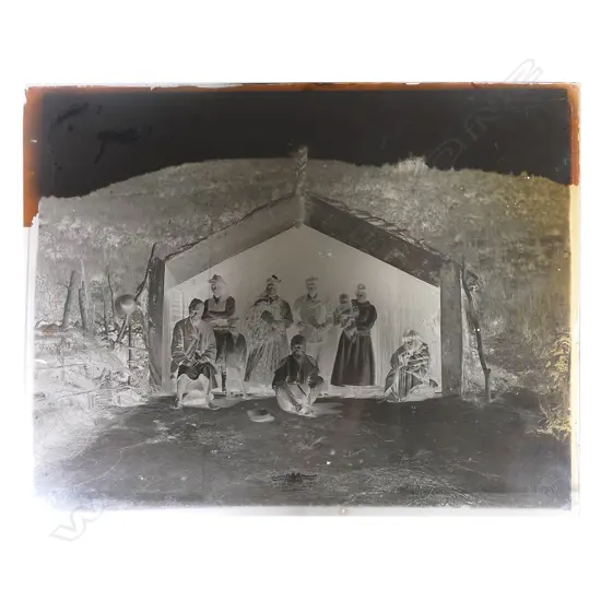 19thC photographer unknown two full glass plate negatives of a Māori figure groups in whare and in front of a marae,