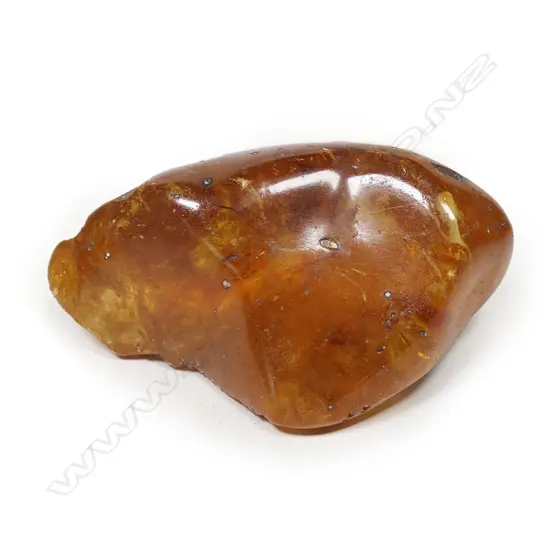 A small polished translucent kauri gum boulder,