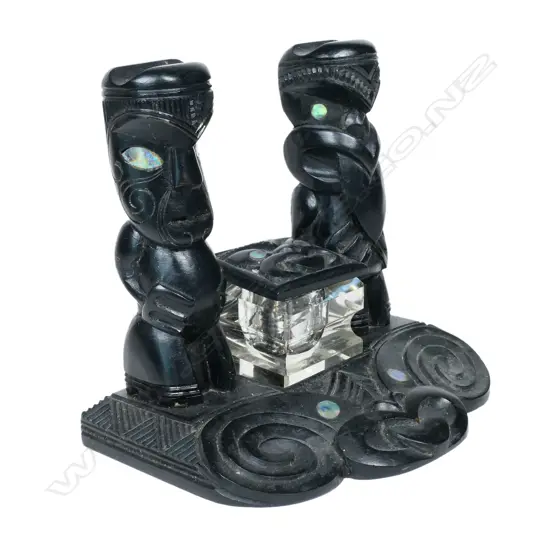 A Māori carved desk stand, ebonised timber,