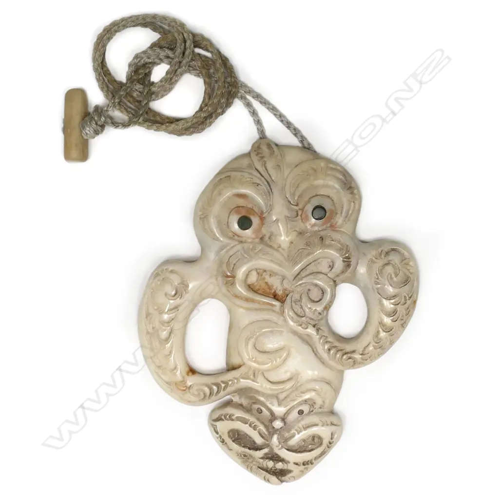 An unusual bone hei tiki, with lower abdomen and legs carved to display a secondary head, Image 1++