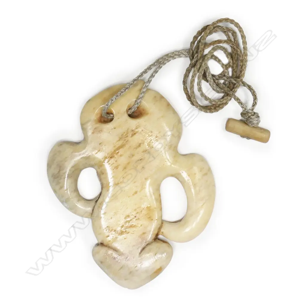 An unusual bone hei tiki, with lower abdomen and legs carved to display a secondary head, Image 1++
