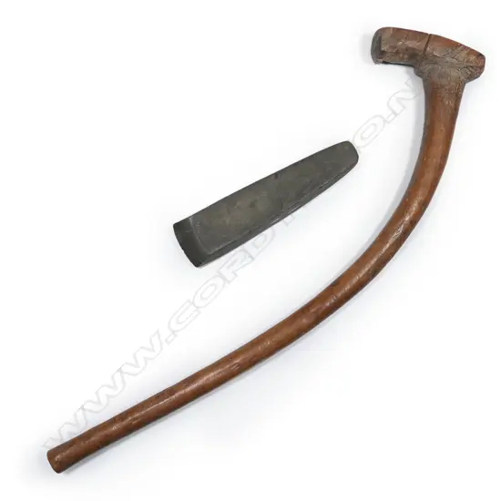 A large Māori pre-European toki (adze) together with a wooden haft,