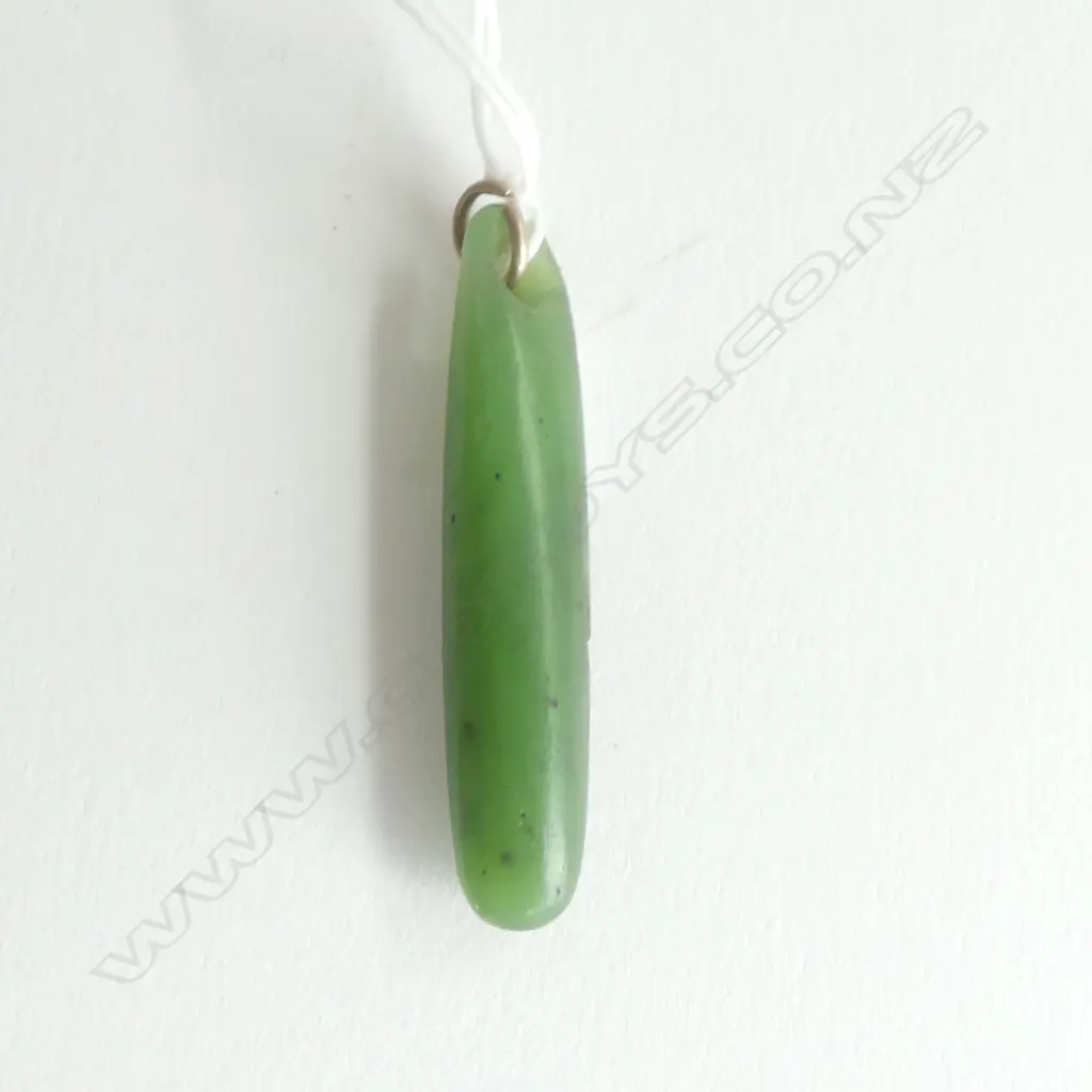 An old Māori pounamu kuru (pendant) stone tooled, Image 1++