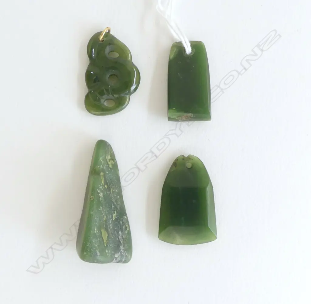 Four small pounamu Māori design carvings Image 1++